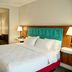 Hampton Inn & Suites by Hilton Cathedral City Palm Springs guest room with king bed and sitting area