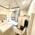 Amrit Villa, New Delhi guest room with double bed, wardrobe, wall-mounted TV, and window with curtains