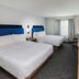 Hampton Inn & Suites by Hilton Tomball Houston NW guest room with two beds and TV in Tomball