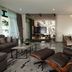 Fraser Suites Singapore living and dining area with modern furniture and chandelier in Singapore