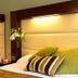 Treacy's Hotel Enniscorthy guest room with two beds, striped pillows and bedside flowers
