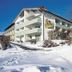 Hotel Landgasthof Hohenauer Hof in Hohenau, snowy hillside exterior with balconies and glass atrium