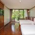 Comsaed River Kwai Resort in Kanchanaburi guest room with two beds and a garden-view balcony