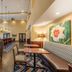 Hampton Inn & Suites Hopkinsville lobby with seating area, high ceilings, and colorful wall art