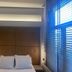 Palladion Boutique Hotel in Árgos, a guest room with a large bed, wall headboard, and window blinds