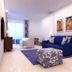 Tahití Playa Suites in Santa Susanna: bright suite with blue sofa, patterned ottoman and sea-view balcony