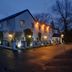 Eglinton Arms Hotel, BW Premier Collection in Glasgow, exterior at dusk with lit windows and wet pavement