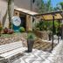 Hotel Serra Everest entrance with stone steps, covered canopy, bench, and tropical landscaping in Nova Friburgo