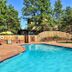 The Historic Crags Lodge in Estes Park: outdoor pool with deck, fence, and pine trees