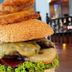 The Shakespeare Hotel, Auckland: close-up of a cheeseburger with onion rings and fries on a table