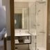 Hôtel Restaurant Au Boeuf in Blaesheim: bedroom with adjoining glass shower room and vanity