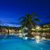 I Giardini di Cala Ginepro Hotel Resort in Cala Liberotto, palm-fringed pool at dusk