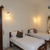 Hotel Harasar Haveli in Bikaner guest room with two single beds and an arched doorway