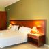Esmeralda Hotel in Kremastí guest room with double bed, wooden headboard, desk and wardrobe