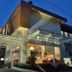 Uny Hotel in Yogyakarta exterior at dusk with glass entrance canopy and illuminated lobby