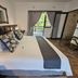 Leopard Corner Lodge, Saint Lucia: king bed in a guest room with balcony access and forest view