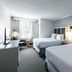Gravity Haus Steamboat guest room with two beds, desk, and window seating in Steamboat Springs