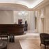 Worldhotel Cristoforo Colombo Milan lobby with curved reception desk and chandelier lighting
