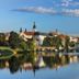 Hotel City Pisek in Písek with river reflections, bridge and town skyline under a blue sky