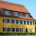 Klozbücher - Das Landhotel in Ellwangen, yellow facade with red tiled roof and blue shutters