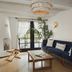 The Scott Resort & Spa Scottsdale living room with navy sofa, coffee table, and French doors to greenery