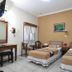 Hotel Mataram Malioboro Yogyakarta room with two twin beds and simple seating in Yogyakarta