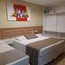 Hotel Três Caravelas Fortaleza room with two single beds, wall art and open closet