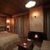 Vitina House in Vytina bedroom with fireplace, wooden ceiling, and bedside wall lights