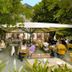 Austria Classic Hotel Hölle Salzburg outdoor garden terrace with guests dining under umbrellas