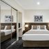 Quest Narre Warren bedroom with queen bed, mirrored closet and large window blinds