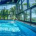 Indoor pool with floor-to-ceiling windows and mountain views at Hotel Diament Ustron, Ustroń