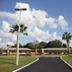 Prince of Wales Motel in Lake Wales with a curved driveway, palm trees, and low-rise motel buildings