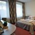 Hotel Három Gúnár, Kecskemét guest room with double bed, bedside lamps, and large windows