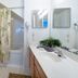 Villas at Seven Dwarfs Lane Resort Kissimmee bathroom with shower, vanity, and mirror
