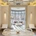El Palauet Modernist Suites Barcelona, elegant suite lounge with marble table and bay window in Barcelona