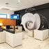 Tahití Playa Suites lobby lounge in Santa Susanna with white sofas and a large black-and-white wall mural