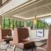Sheraton Suites Akron Cuyahoga Falls restaurant with tall windows and booth seating overlooking trees