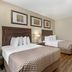 Best Western Plus St. Albert guest room with two double beds, nightstand, lamp and wood flooring