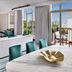 Address Montgomerie Dubai suite with sofa, dining table, balcony and city view