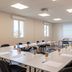 B&B HOTEL Agen Castelculier meeting room with U-shaped tables, projector screen and flip chart in Castelculier