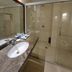 Xinji Garden Hotel in Nanchang bathroom with marble vanity and glass-enclosed shower