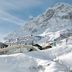 Hotel Zurserhof in Zürs beside a snow-covered mountain slope with alpine lodge buildings