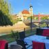 Hotel Icon in Győr outdoor riverfront dining terrace with city tower and bridge view