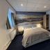 Sea You Hotel Noordwijk guest room with double bed and seaside mural in Noordwijk