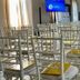 Antico Borgo di Sutri conference room with rows of white chairs and presentation screens in Sutri
