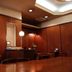 Hiroshima Ekimae Green Hotel Hiroshima wood-paneled lounge with tables and warm lighting