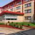 Residence & Conference Centre - Oakville exterior with red-roofed entrance and courtyard