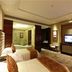 Hakka Park International Hotel in Meizhou room with twin beds, bathtub, TV, and seating area
