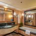 Jiajin Hotel International in Zhengzhou bathroom with marble vanity, large mirror, and soaking tub