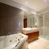 Tall Timbers Tasmania in Smithton bathroom with jetted tub, vanity, and glass-enclosed shower